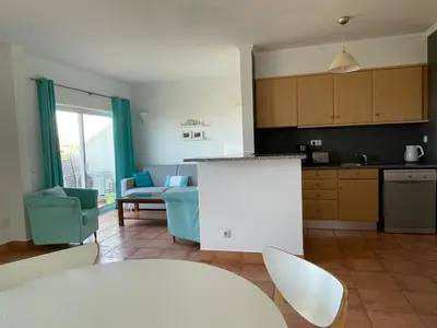 a kitchen and living room with a table and chairs at Lagos 61 in Lagos
