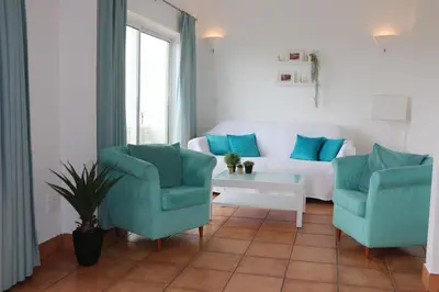 a living room with two chairs and a couch at Lagos 61 in Lagos