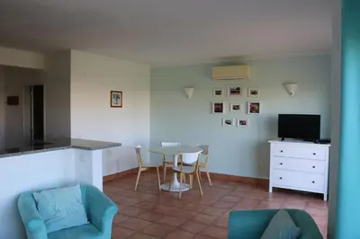 a living room with a table and chairs and a tv at Lagos 61 in Lagos