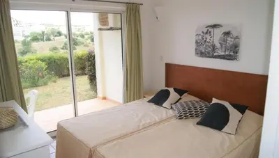 a bedroom with a large bed with a large window at Lagos Marc & Cathy in Lagos