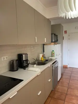 a kitchen with white cabinets and a sink at Lagos Marc & Cathy in Lagos