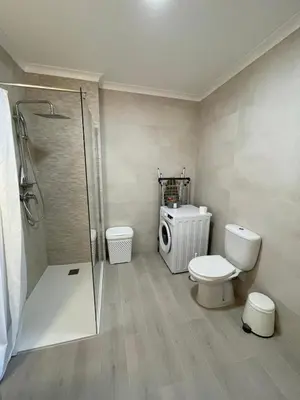 a bathroom with a toilet and a glass shower at Lagos Marc & Cathy in Lagos