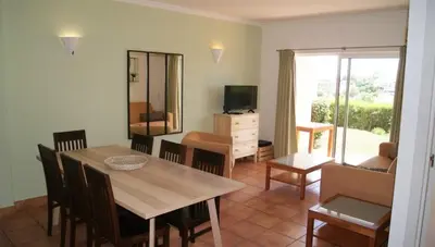 a living room with a table and chairs and a television at Lagos Marc & Cathy in Lagos