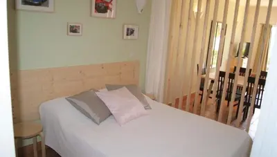 a bedroom with a bed with white sheets and pillows at Lagos Marc & Cathy in Lagos