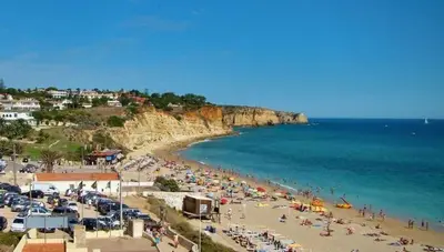 a beach with a crowd of people and the ocean at Lagos Marc & Cathy in Lagos