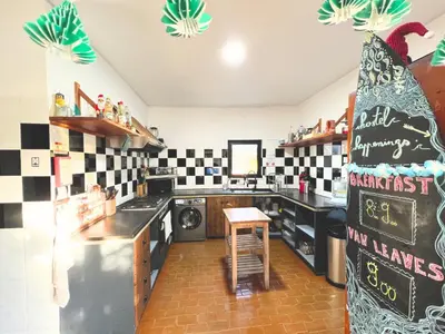 a kitchen with black and white checkered walls at Algarve Surf Camp & Hostel Sagres in Sagres