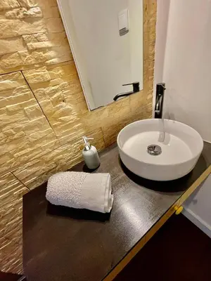 a bathroom with a white sink and a mirror at Palheiro do Avô in Santa Cruz
