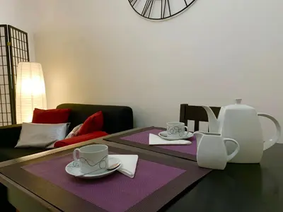 a table with two cups and saucers on it at Black & White by Homie in Funchal