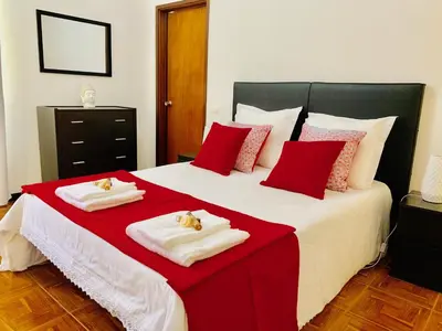 a bedroom with a large bed with red and white pillows at Black & White by Homie in Funchal