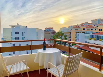 a table and chairs on a balcony with a view of the city at Black & White by Homie in Funchal