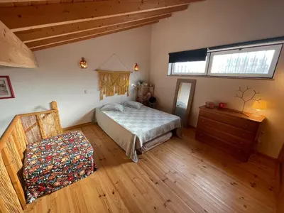 a bedroom with a bed and a dresser and a window at CASA BIKAS in Barão de São Miguel