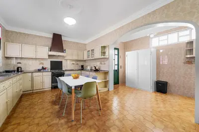 a large kitchen with a table and chairs at Cumbres Villa in Funchal