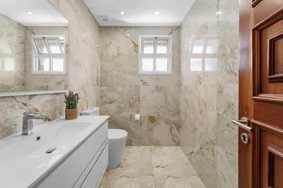 a bathroom with a sink and a toilet at Cumbres Villa in Funchal