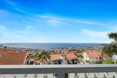 a view of the ocean from the balcony of a house at Cumbres Villa in Funchal