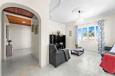 a living room with a couch and a tv at Cumbres Villa in Funchal