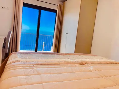 a bedroom with two beds with white sheets at Villa da Bisa with heated swiming pool in Arco da Calheta