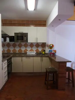 a kitchen with white cabinets and a counter top at Cantinho Das Estrelas, Luz Lagos in Luz
