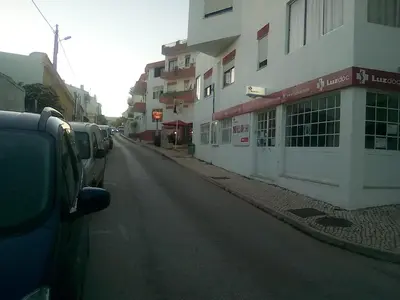 a street with cars parked on the side of a building at Cantinho Das Estrelas, Luz Lagos in Luz