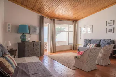 a living room with a couch and a table at Calheta House in Luz in Luz