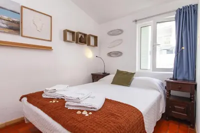 a bedroom with a bed with towels on it at Calheta House in Luz in Luz