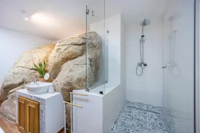 a bathroom with a shower and a sink at Salema Family Home in Salema