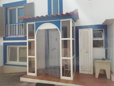 a toy house with a cage in front of it at Burgau125 - villa near the beach in Vila do Bispo