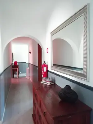 a room with a dresser with a large mirror on the wall at Burgau125 - villa near the beach in Vila do Bispo