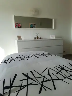 a white bedroom with a bed and a white dresser at Burgau125 - villa near the beach in Vila do Bispo