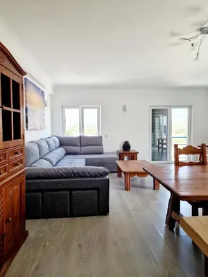 a living room with a couch and a table at Burgau125 - villa near the beach in Vila do Bispo