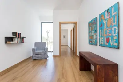 a living room with a table and a chair at Villa Nooma in Carrapateira