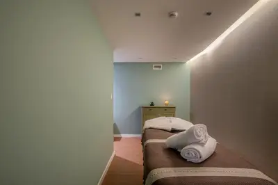 a room with two beds with towels on them at Pestana Churchill Bay in Câmara de Lobos