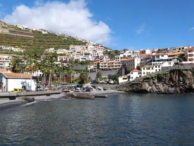 a body of water with houses on a hill at Pestana Churchill Bay in Câmara de Lobos