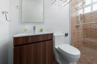 a bathroom with a toilet and a sink and a shower at Villa Vista Mar in Funchal