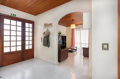 a hallway with a door and a living room at Villa Vista Mar in Funchal