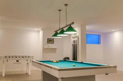 a living room with a pool table in it at A&M House II Luxury Holidays Home in Arco da Calheta