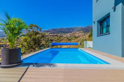 a swimming pool in the backyard of a house at A&M House II Luxury Holidays Home in Arco da Calheta