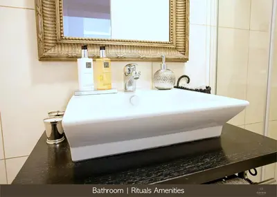 a desk with a chair next to a stone wall at Cayres Suites Carmo in Funchal