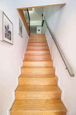a staircase with wooden floors and white walls at Cayres Suites Carmo in Funchal