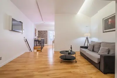 a living room with a couch and a table at Cayres Suites Carmo in Funchal