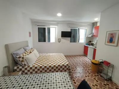a small room with a bed and a kitchen at Apartamento Burgo 