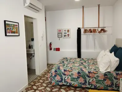 a bedroom with a bed with a colorful comforter at Apartamento Burgo 