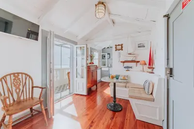 a living room with a table and a chair at Casa da Praia in Câmara de Lobos