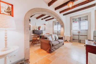 a living room with a couch and a table at Casa da Praia in Câmara de Lobos