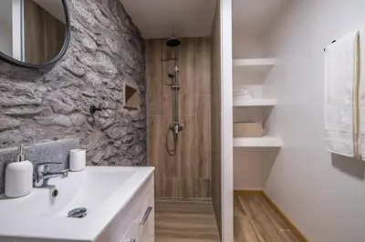 a bathroom with a sink and a shower at Recanto Jardim Do Mar in Jardim do Mar