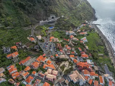 an aerial view of a village next to the ocean at Recanto Jardim Do Mar in Jardim do Mar