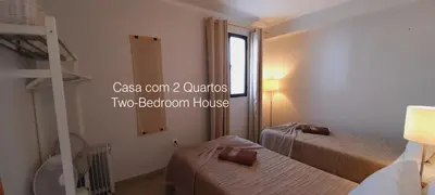 a bedroom with a bed and a table with a lamp at First Balcony - Porto Santo in Porto Santo