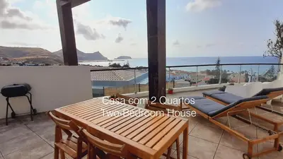 a room with a balcony with a view of the ocean at First Balcony - Porto Santo in Porto Santo