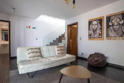 a living room with a white couch and a table at Villa Ocean Sight by LovelyStay in Funchal