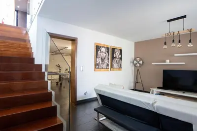 a living room with a staircase and a television at Villa Ocean Sight by LovelyStay in Funchal