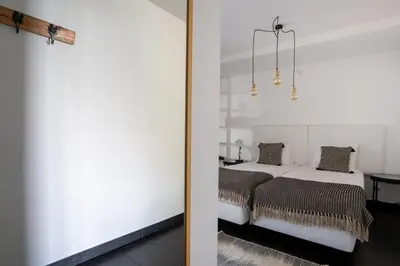 a bedroom with a bed next to a door at Villa Ocean Sight by LovelyStay in Funchal